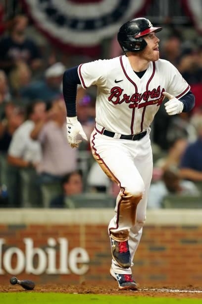 Freddie Freeman of the Atlanta Braves reacts after hitting a solo home run in the bottom the eighth inning during Game 4 of the NLDS between the...