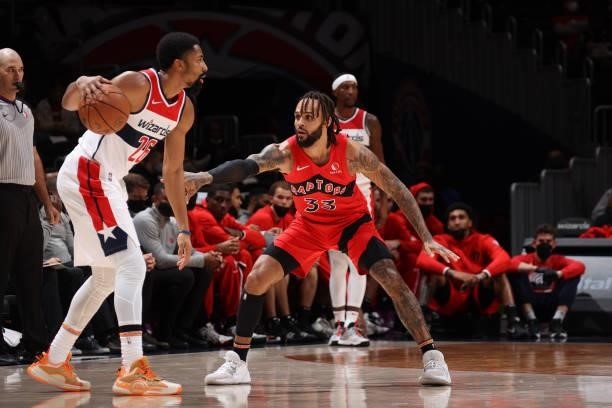 Gary Trent Jr. #33 of the Toronto Raptors plays defense on Spencer Dinwiddie of the Washington Wizards during a preseason game on October 12, 2021 at...