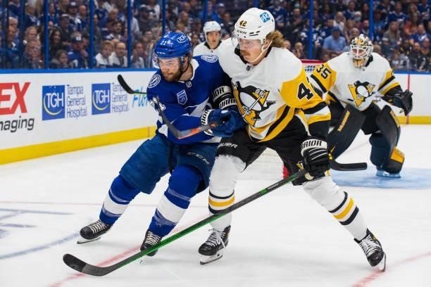 Brayden Point of the Tampa Bay Lightning skates against Kasperi Kapanen of the Pittsburgh Penguins during the first period at Amalie Arena on October...