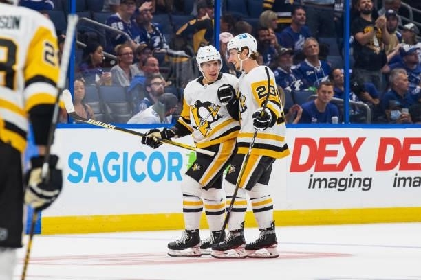 The Pittsburgh Penguins celebrates a goal against the Tampa Bay Lightning during the third period at Amalie Arena on October 12, 2021 in Tampa,...