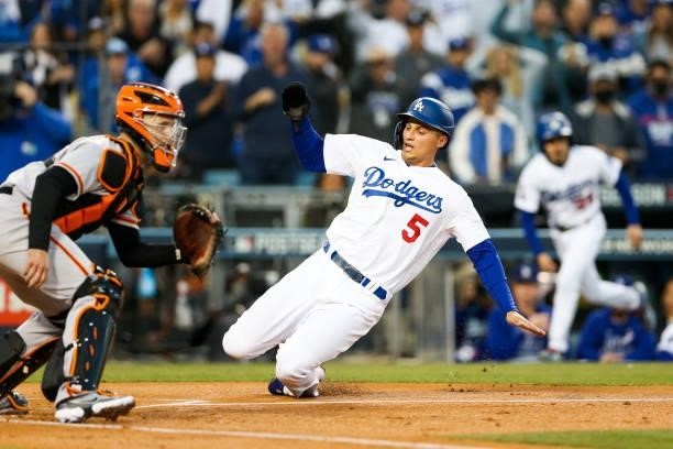 Corey Seager of the Los Angeles Dodgers slides into home to score in the first inning during Game 4 of the NLDS between the San Francisco Giants and...