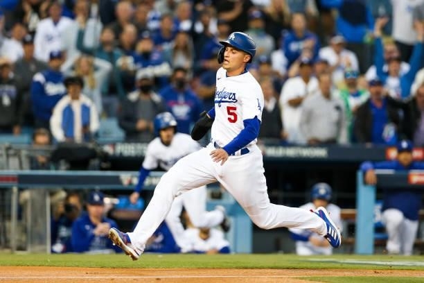 Corey Seager of the Los Angeles Dodgers slides into home to score in the first inning during Game 4 of the NLDS between the San Francisco Giants and...