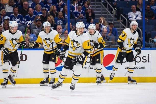 Brian Boyle of the Pittsburgh Penguins celebrates a goal with teammates Sam Lafferty and John Marino against the Tampa Bay Lightning during the...
