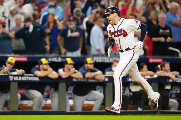 Freddie Freeman of the Atlanta Braves celebrates after hitting a solo home run in the bottom of the eighth inning during Game 4 of the NLDS between...