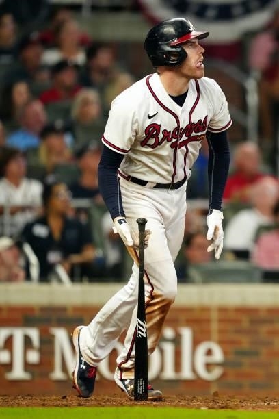 Freddie Freeman of the Atlanta Braves reacts after hitting a solo home run in the bottom the eighth inning during Game 4 of the NLDS between the...