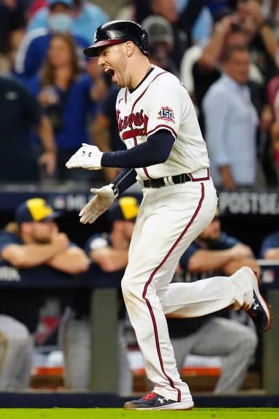 Freddie Freeman of the Atlanta Braves celebrates after hitting a solo home run in the bottom the eighth inning during Game 4 of the NLDS between the...