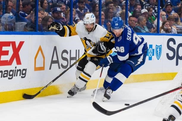 Mikhail Sergachev of the Tampa Bay Lightning skates against Bryan Rust of the Pittsburgh Penguins during the second period at Amalie Arena on October...