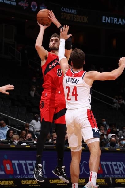 Sam Dekker of the Toronto Raptors shoots a three point basket during a preseason game against the Washington Wizards on October 12, 2021 at Capital...