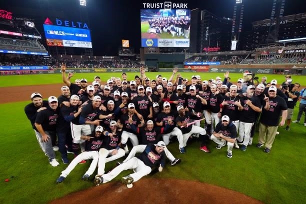 Members of the Atlanta Braves celebrate after defeating the Milwaukee Brewers 5-4 in Game 4 of the NLDS at Truist Park on Tuesday, October 12, 2021...
