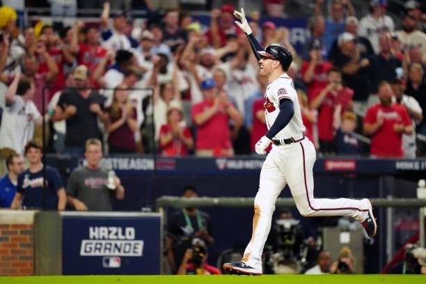 Freddie Freeman of the Atlanta Braves celebrates after hitting a solo home run in the bottom the eighth inning during Game 4 of the NLDS between the...