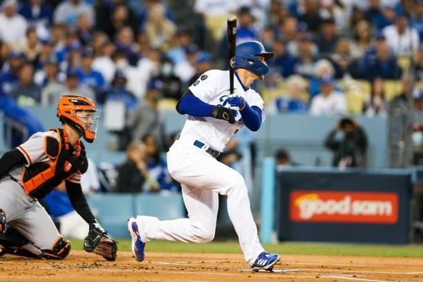 Corey Seager of the Los Angeles Dodgers hits a single in the first inning during Game 4 of the NLDS between the San Francisco Giants and the Los...