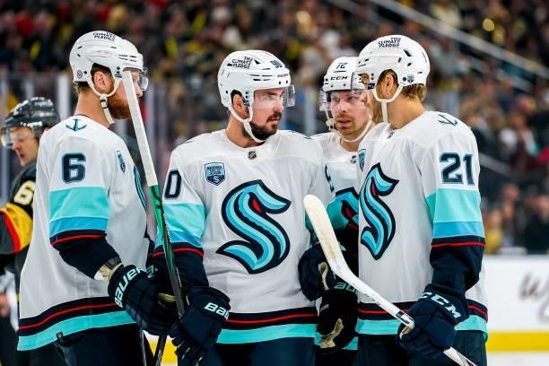 Adam Larsson, Marcus Johansson, Joonas Donskoi, and Alex Wennberg of the Seattle Kraken discuss strategy during a first period stoppage of play...