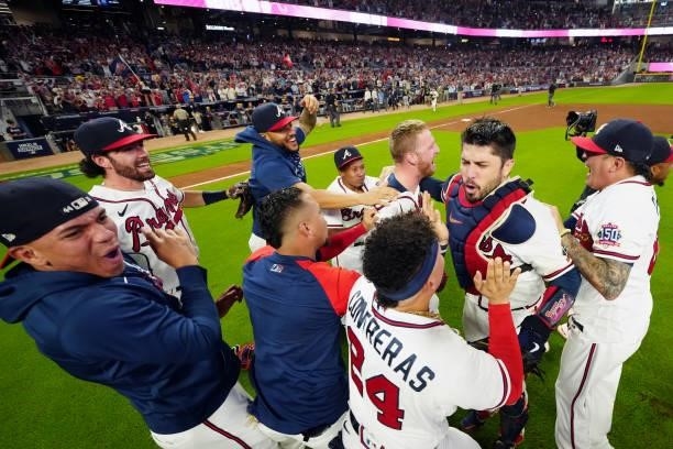 Members of the Atlanta Braves celebrate after they defeated the Milwaukee Brewers 5-4 in Game 4 of the NLDS at Truist Park on Tuesday, October 12,...