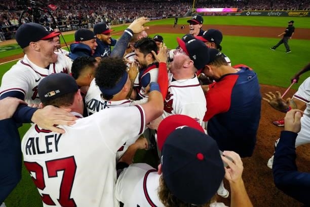 Members of the Atlanta Braves celebrate after they defeated the Milwaukee Brewers 5-4 in Game 4 of the NLDS at Truist Park on Tuesday, October 12,...