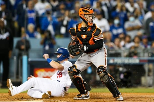 Buster Posey of the San Francisco Giants looks on after a forceout at home in the third inning during Game 4 of the NLDS between the San Francisco...