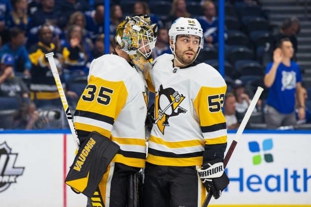 Goalie Tristan Jarry and Mark Friedman of the Pittsburgh Penguins celebrate the win against the Tampa Bay Lightning at Amalie Arena on October 12,...
