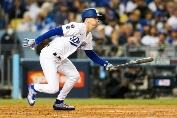 Walker Buehler of the Los Angeles Dodgers hits into an error to reach first in the fourth inning during Game 4 of the NLDS between the San Francisco...