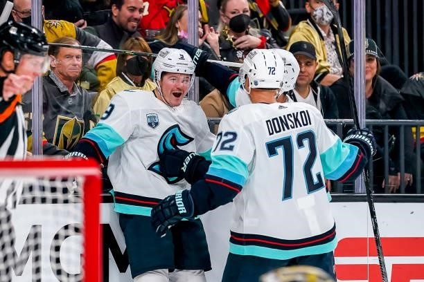 Ryan Donato of the Seattle Kraken celebrates his second period goal against the Vegas Golden Knights with teammate Joonas Donskoi at T-Mobile Arena...