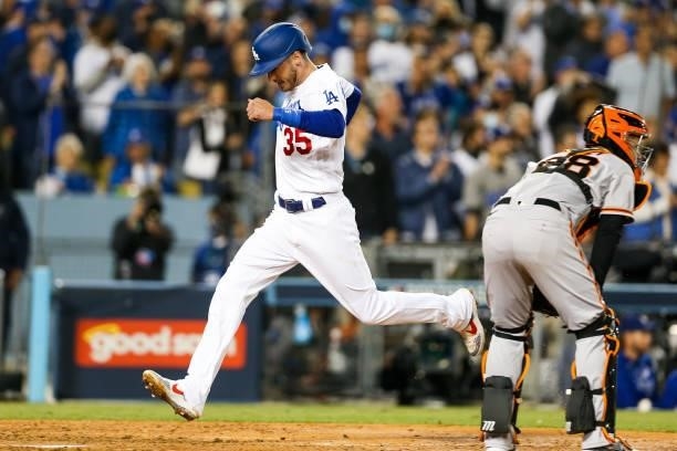 Cody Bellinger of the Los Angeles Dodgers scores on a sac fly in the fifth inning during Game 4 of the NLDS between the San Francisco Giants and the...