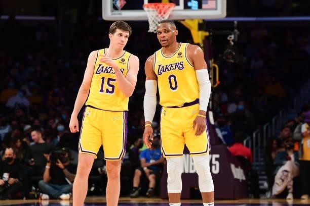 Austin Reaves of the Los Angeles Lakers talks to teammate Russell Westbrook during a preseason game against the Golden State Warriors on October 12,...