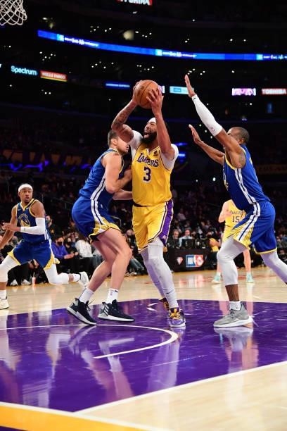 Anthony Davis of the Los Angeles Lakers drives to the basket during a preseason game against the Golden State Warriors on October 12, 2021 at STAPLES...
