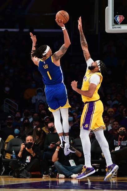 Anthony Davis of the Los Angeles Lakers reaches to block a shot by Damion Lee of the Golden State Warriors during a preseason game on October 12,...