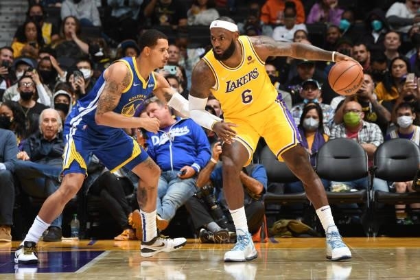 LeBron James of the Los Angeles Lakers drives to the basket during a preseason game against the Golden State Warriors on October 12, 2021 at STAPLES...