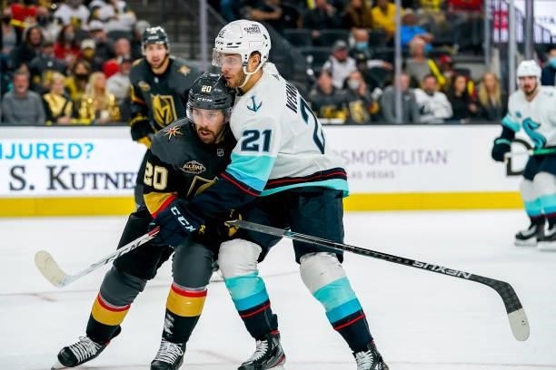 Chandler Stephenson of the Vegas Golden Knights battles for position against Alex Wennberg of the Seattle Kraken during second period action at...