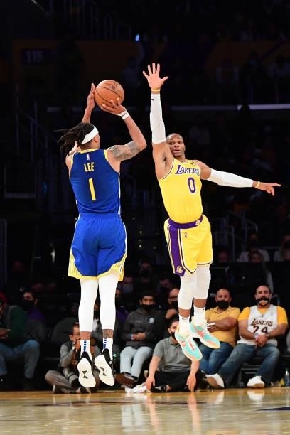 Russell Westbrook of the Los Angeles Lakers reaches to attempt to block a shot by Damion Lee of the Golden State Warriors during a preseason game on...