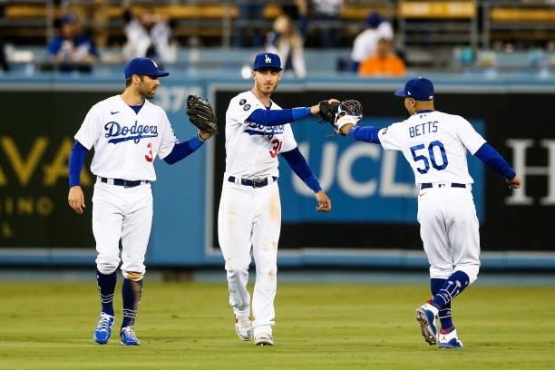 Mookie Betts, Cody Bellinger and Chris Taylor of the Los Angeles Dodgers react after the final out of Game 4 of the NLDS between the San Francisco...