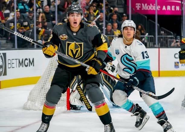 Zach Whitecloud of the Vegas Golden Knights and Brandon Tanev of the Seattle Kraken keep an eye on the play during first period action at T-Mobile...