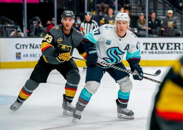 Jaden Schwartz of the Seattle Kraken and Alec Martinez of the Vegas Golden Knights keep an eye on the play during third period action at T-Mobile...