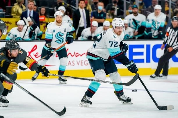 Joonas Donskoi of the Seattle Kraken plays the puck to avoid Jonathan Marchessault of the Vegas Golden Knights during second period action at...