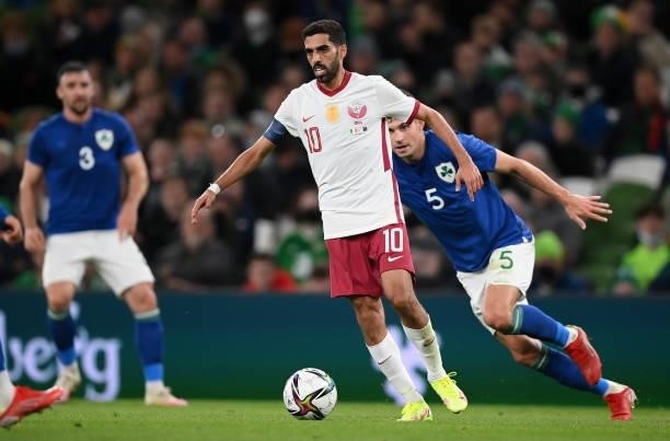 Dublin , Ireland - 12 October 2021; Hassan Alhaydos of Qatar in action against John Egan of Republic of Ireland during the international friendly...
