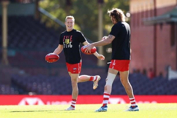 Isaac Heeney of the Swans and Tom Hickey of the Swans warm up during the round 12 AFL match between the St Kilda Saints and the Sydney Swans at...