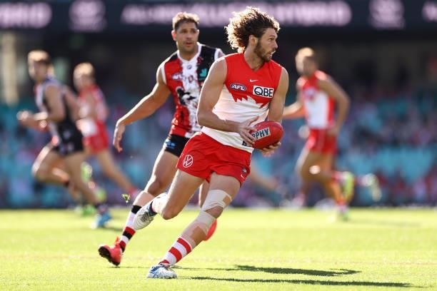 Tom Hickey of the Swans gathers the ball infront of Paddy Ryder of the Saints during the round 12 AFL match between the St Kilda Saints and the...
