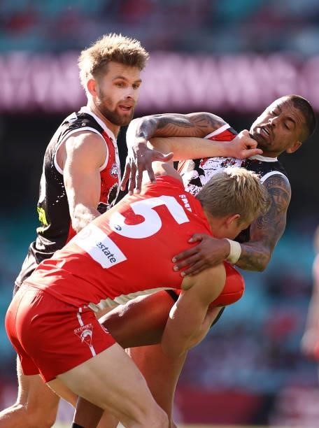 Isaac Heeney of the Swans is tackled by Bradley Hill of the Saints during the round 12 AFL match between the St Kilda Saints and the Sydney Swans at...