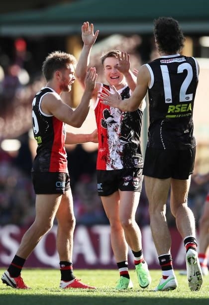 Ryan Byrnes of the Saints celebrates with team mates after kicking a goal during the round 12 AFL match between the St Kilda Saints and the Sydney...