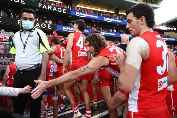Tom Hickey of the Swans high fives fans after winning the round 12 AFL match between the St Kilda Saints and the Sydney Swans at Sydney Cricket...