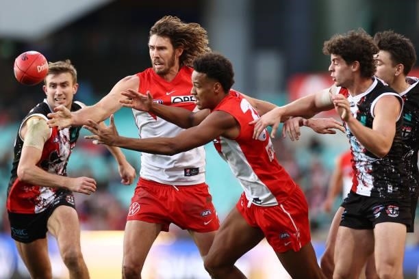 Tom Hickey and Joel Amartey of the Swans gather the ball during the round 12 AFL match between the St Kilda Saints and the Sydney Swans at Sydney...