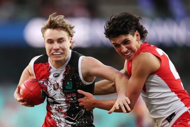 Ryan Byrnes of the Saints is challenged by Justin McInerney of the Swans during the round 12 AFL match between the St Kilda Saints and the Sydney...