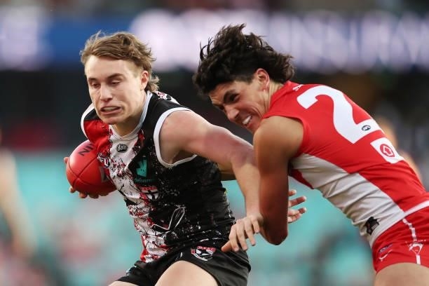 Ryan Byrnes of the Saints is challenged by Justin McInerney of the Swans during the round 12 AFL match between the St Kilda Saints and the Sydney...