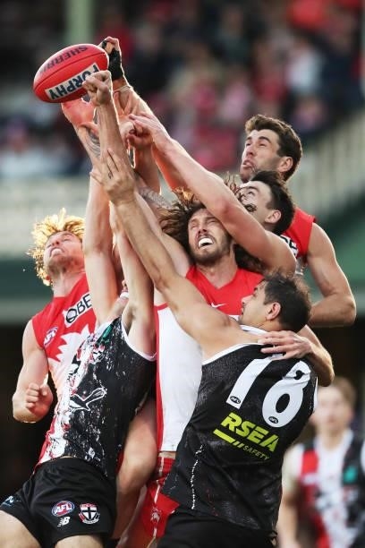Tom Hickey and Robbie Fox contest the ball against Paddy Ryder of the Saints during the round 12 AFL match between the St Kilda Saints and the Sydney...