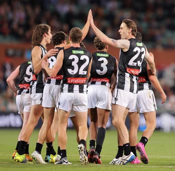 Trent Bianco of the Magpies celebrates with his team mates after kicking a goal during the round 12 AFL match between the Adelaide Crows and the...