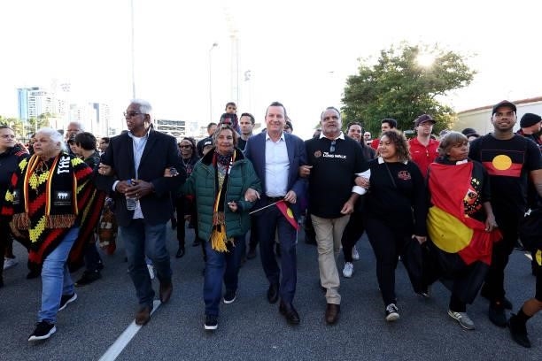 West Australian Premier Mark MGowan and Michael Long lead the Long Walk from the WACA to Optus Stadium during the round 12 AFL match between the...