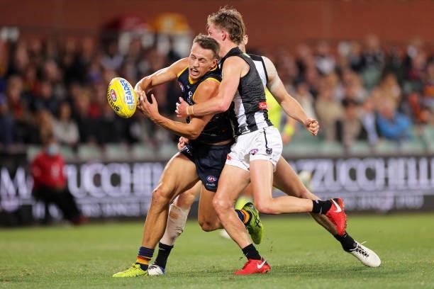 Tom Doedee of the Crows is tackled during the round 12 AFL match between the Adelaide Crows and the Collingwood Magpies at Adelaide Oval on June 05,...