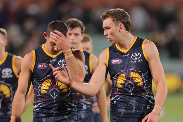 Taylor Walker of the Crows and Riley Thilthorpe of the Crows walk from the ground during the round 12 AFL match between the Adelaide Crows and the...