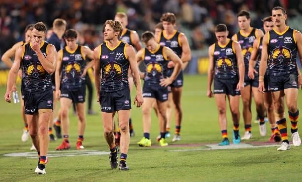 Paul Seedsman of the Crows and Rory Sloane of the Crows walk from the ground during the round 12 AFL match between the Adelaide Crows and the...