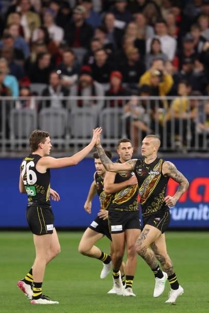 Dustin Martin of the Tigers celebrates a goal during the round 12 AFL match between the Essendon Bombers and the Richmond Tigers at Optus Stadium on...
