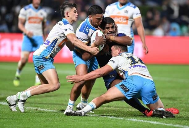 Tui Kamikamica of the Storm is tackled during the round 13 NRL match between the Melbourne Storm and the Gold Coast Titans at Sunshine Coast Stadium,...